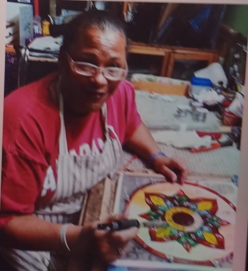 Kim Edwards at her workbench, working on a jewel-toned stained-glass star