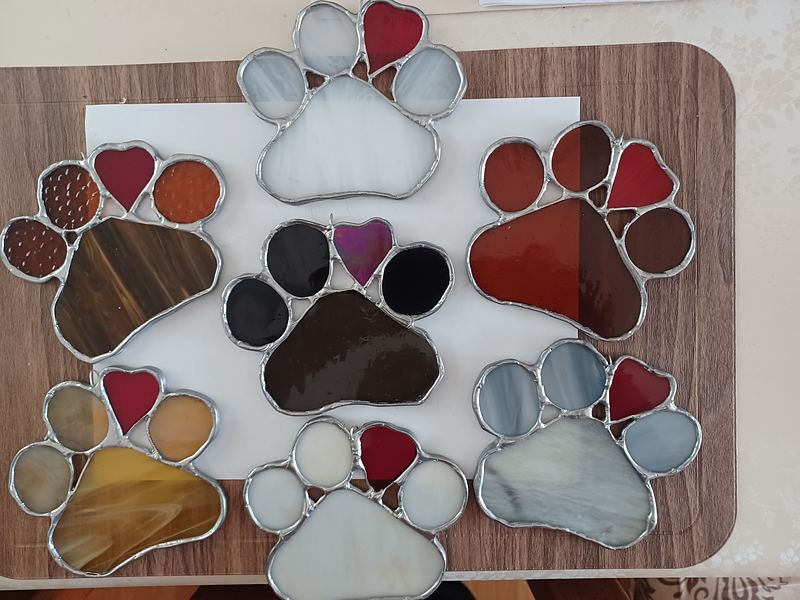 Stained-glass paw prints with hearts in many colors by Kim’s Creative Cuts